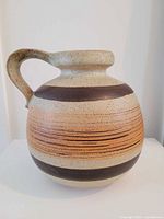 Front view of rounded jug showing banded decoration