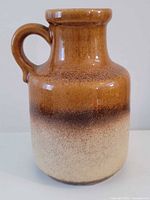 Front view of ceramic jug vase showing handle and ombre glaze