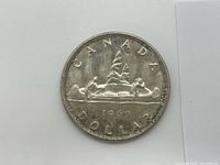 Reverse of 1960 Canadian silver dollar showing Voyageur design and date