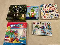 Front view of all five boxed items on carpet