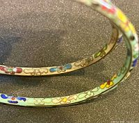 Close-up of cloisonné detailing on bangles’ rims