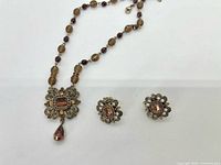 Full view of necklace and both earrings