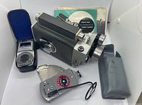 Camera, light meter, flash, manuals, and cases overview