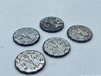 Five Victory nickels reverse side showing torch design and dates