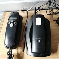 Corded handset and cordless base side by side on table