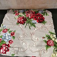 Folded barkcloth panel showing overall floral and scroll pattern