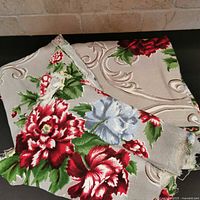 stacked barkcloth pieces showing pattern and frayed edges