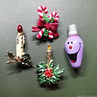 Front view of the four Christmas brooches