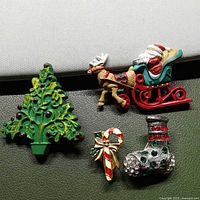 All four Christmas brooch pins grouped