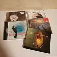 Five CD cases front covers visible