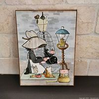 Front of plaque showing illustrated seamstress scene