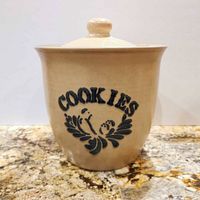 Front view of stoneware cookie jar showing blue COOKIES motif