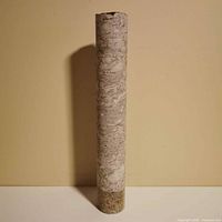 Full view of 14-inch concrete core sample standing upright