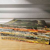 Stack of approximately 20 How and Why Wonder Books showing spines and titles