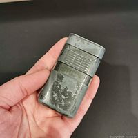 Side view in hand showing size and exterior wear