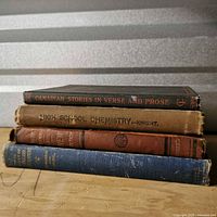 Stack of four textbooks showing spines: Canadian Stories in Verse and Prose, High School Chemistry, English Grammar, Study of English Literature