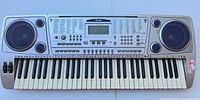 Top view showing all 61 keys, LCD, speakers, controls, pitch bend wheel, key discoloration