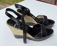 Side profile of Cole Haan black leather beige wedge sandals