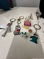 Group shot of five keychains and four pins on tabletop