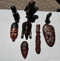Group shot showing all masks and sculptures for count and scale