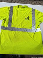 Front view of neon yellow GFL reflective T-shirt showing size, logo, and reflective stripes