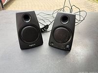 Front view of both Logitech Z130 speakers with attached cables