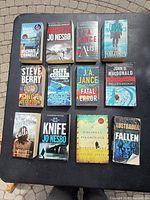 All 12 paperback books laid out in three rows showing covers and titles