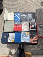All thirteen books arranged on table, covers visible