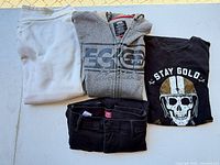 Group shot of all four clothing items folded