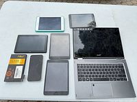 Group shot of all devices including laptop, tablets, phone and screen protector