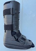 Full lateral view of walking boot showing shell, straps, and toe opening