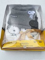 Front view of boxed gift set showing slippers and toque