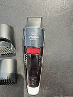 Front view of Philips Norelco vacuum trimmer with two guide combs visible