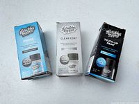 Front view of three boxed bottles: primer, clear coat, touch-up paint