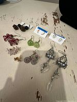 All ten pairs of earrings laid out on tabletop