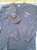 T-shirt, cap and pin overview
