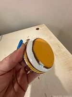 Top view of orange, brown, and white glazed ceramic lid