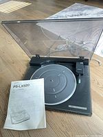 Sony PS-LX520 turntable with lid open, platter, manual, cables visible