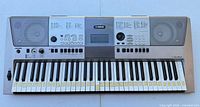 Front view of Yamaha PSR-E413 keyboard showing keys, control panel, speakers