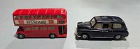 Side view of red double-decker bus and black taxi