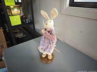 Front view of fabric bunny figurine on wood base