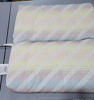 Top view of two-panel pastel striped seat cushion