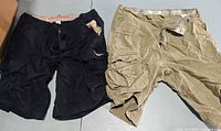 Levi's tan and Unionbay black cargo shorts side by side