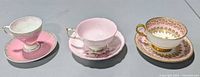 Front view of the three teacup and saucer sets