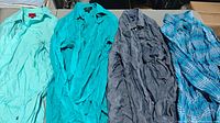 All four shirts side by side showing colors and overall condition