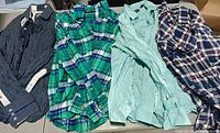 All four shirts laid flat showing colors and patterns