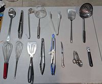 All utensils laid out showing variety and condition