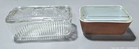 Two complete rectangular butter dishes side by side