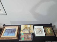 All five wall art pieces displayed on table