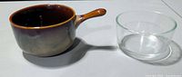 Stoneware handled bowl beside clear glass ramekin